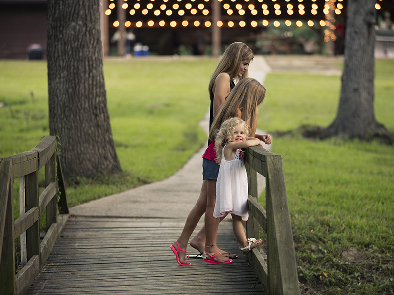 Young girls on the bridge in Grand Central Park community in Conroe