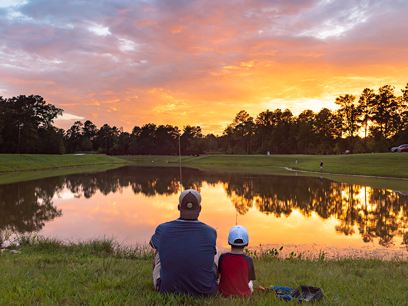 Father and Son watching the sunset in Woodforest Golf Couse North of the Woodlands